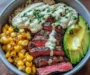 Steak, Avocado, and Roasted Corn Bowl with Cilantro Cream Sauce